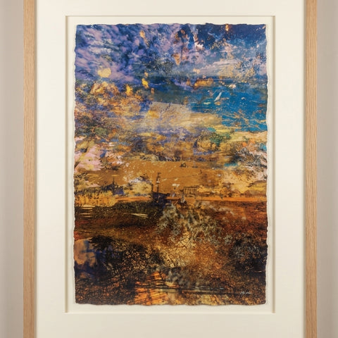 “A Beautiful Transition” glass ash framed fine art print by Durham J White, featuring a layered photographic artwork of coastal land and sea formations in warm ochres, sandy hues, and rich coastal blues.
