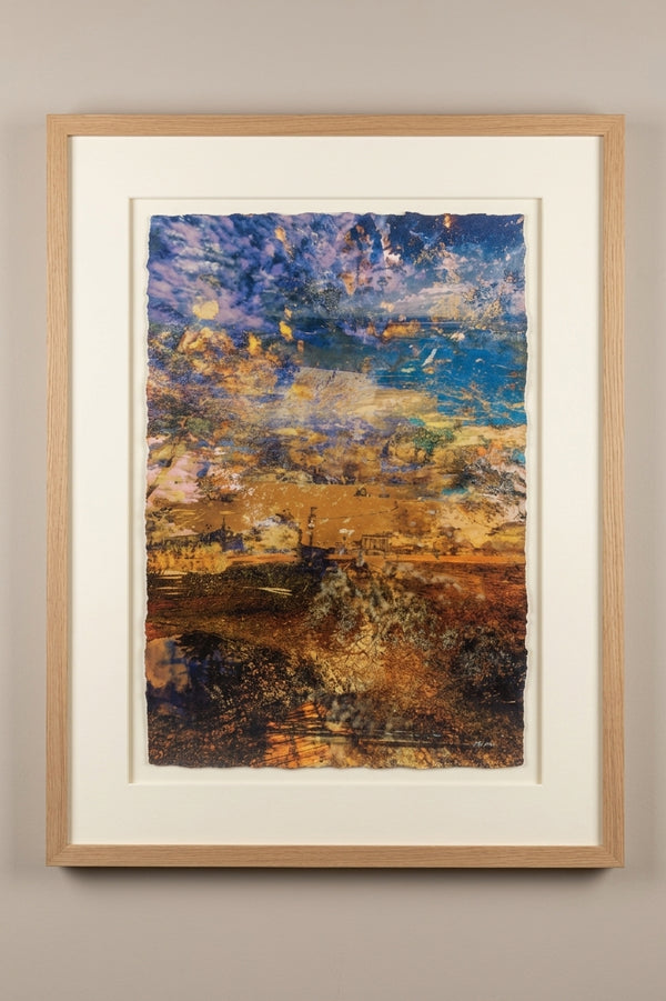 “A Beautiful Transition” glass ash framed fine art print by Durham J White, featuring a layered photographic artwork of coastal land and sea formations in warm ochres, sandy hues, and rich coastal blues.