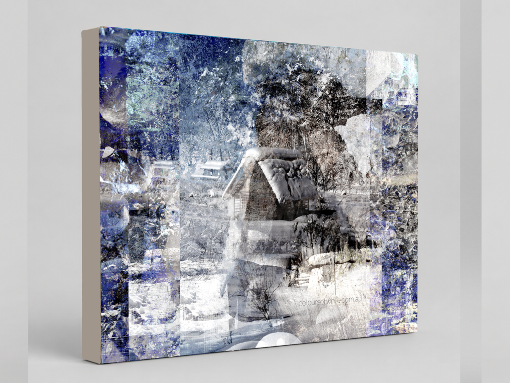 "A Snow Scene" archival canvas print by Durham J White, featuring a Japanese winter layered photographic artwork with snow-capped thatched huts, geometric panelling, sepia tones, luminous whites, and deep midnight blues.