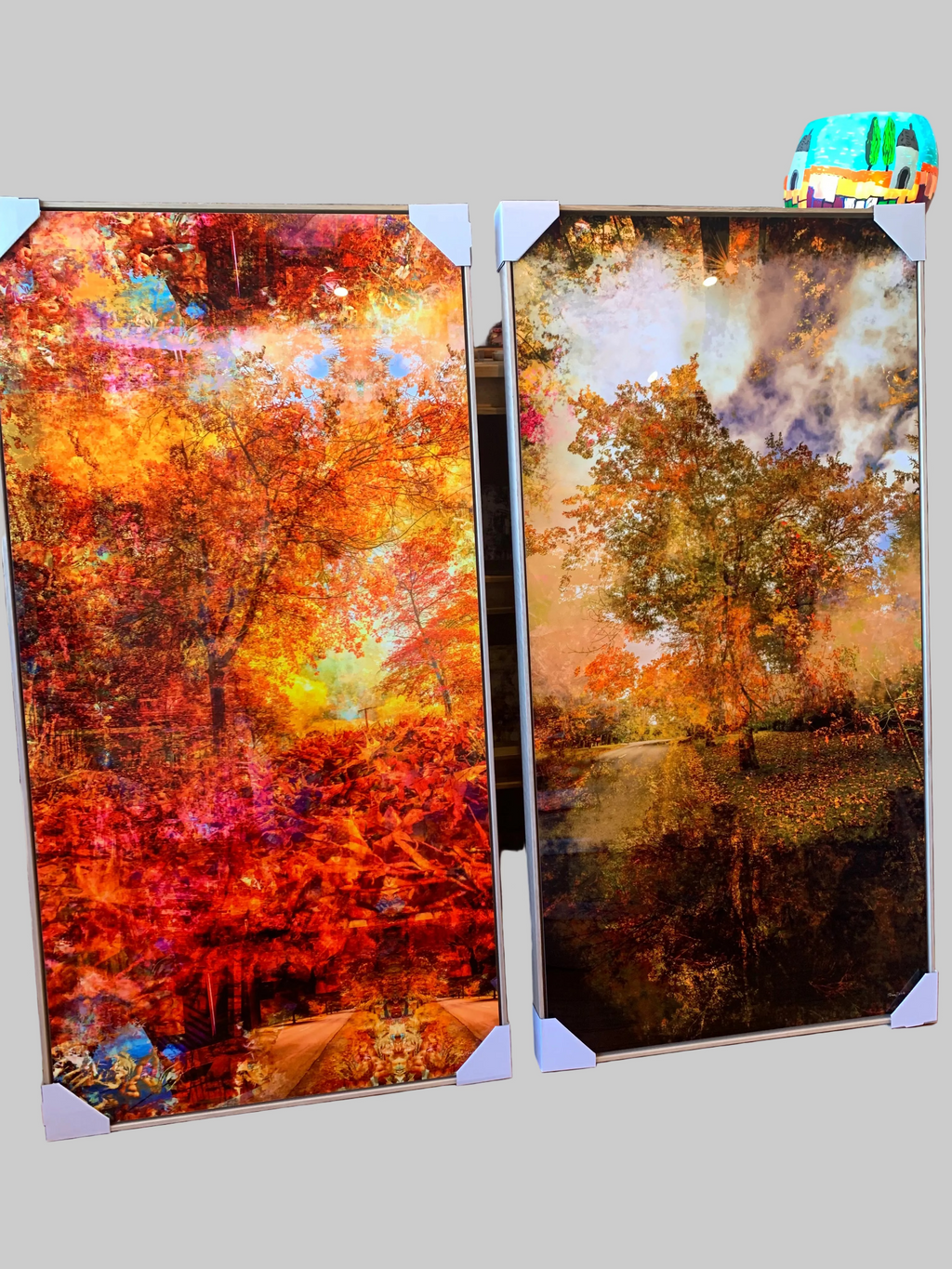 “Grounded” ChromaLuxe metal print by Durham J White, featuring a layered photographic artwork of Honour Avenue in Macedon in saturated burnt oranges, amber tones, and radiant golden yellows.Two Ash box framed artworks of autumn landscapes on a ChromaLuxe Metal surface.