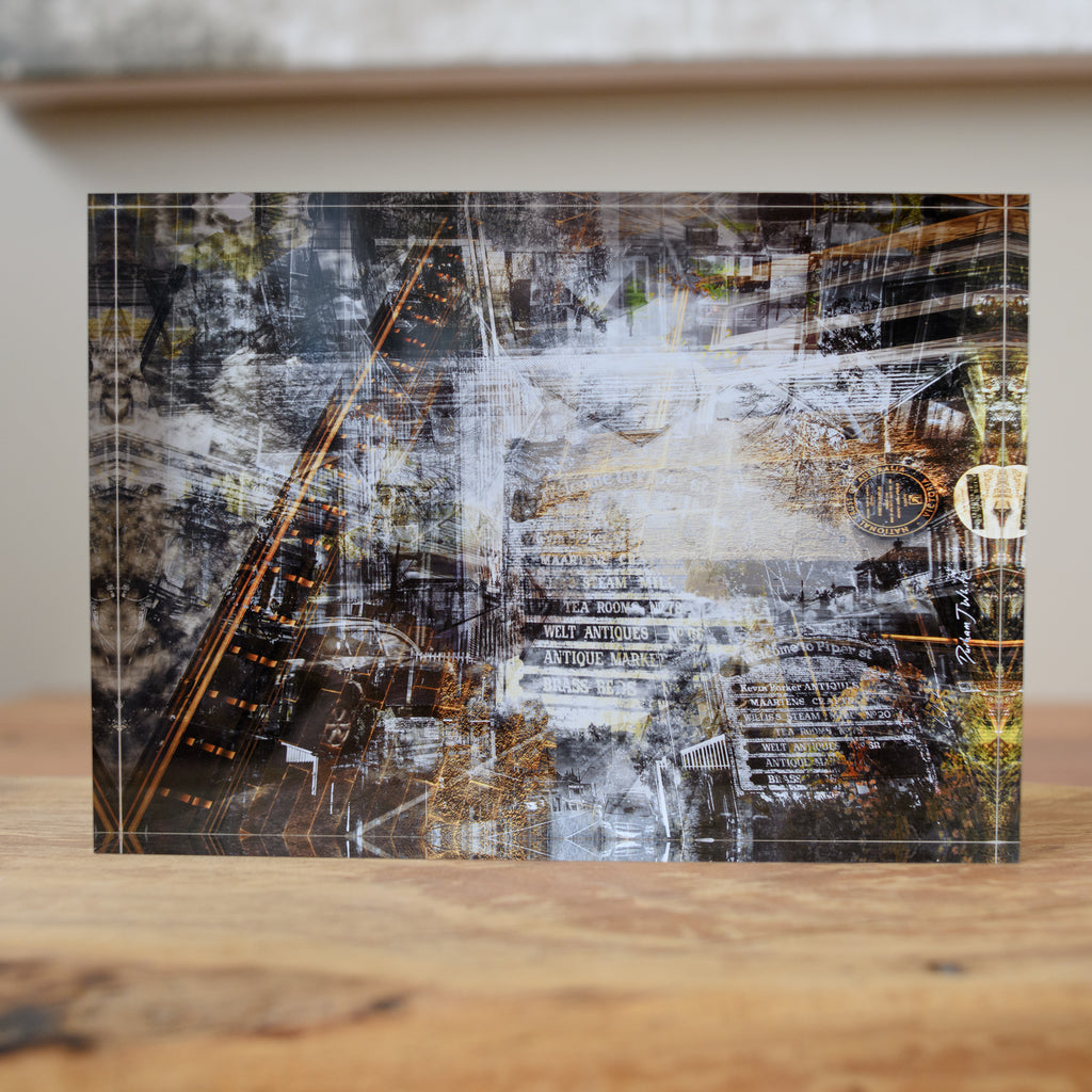 A free-standing art tile featuring a black, white, and gray industrial-themed design with hints of copper.