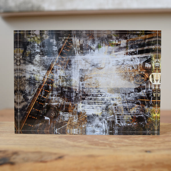 A free-standing art tile featuring a black, white, and gray industrial-themed design with hints of copper.