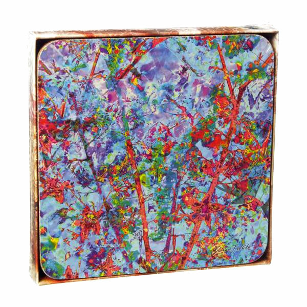 A set of multicolored square coasters with a vibrant floral blossom pattern