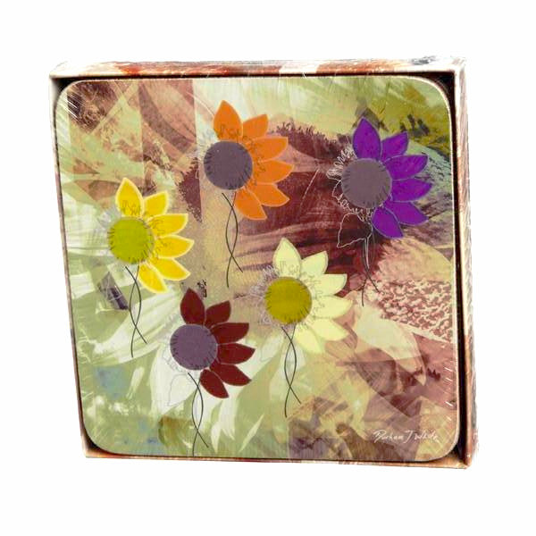 A set of four square coasters with a colorful floral pattern, featuring FleuroSun sunflowers, placed in a brown box with a camouflage-patterned background.