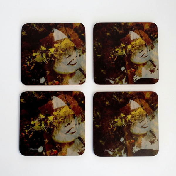 A set of four square coasters with a photograph of a Japanese lady in a forest-like setting.