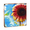 A set of four square coasters featuring a vibrant sunflower design with abstract blue and yellow elements on a white background.