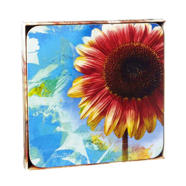 A set of four square coasters featuring a vibrant sunflower design with abstract blue and yellow elements on a white background.