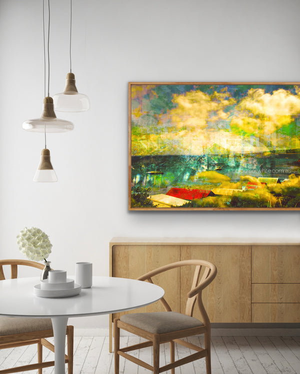 "Bathing in Nostalgia" archival canvas print by Durham J White, featuring Mother's Beach, Mornington, with beach huts, swimmers, shifting turquoise blues, light on the water, and a vibrant splash of red, shown in a neutral-toned living room interior setting.