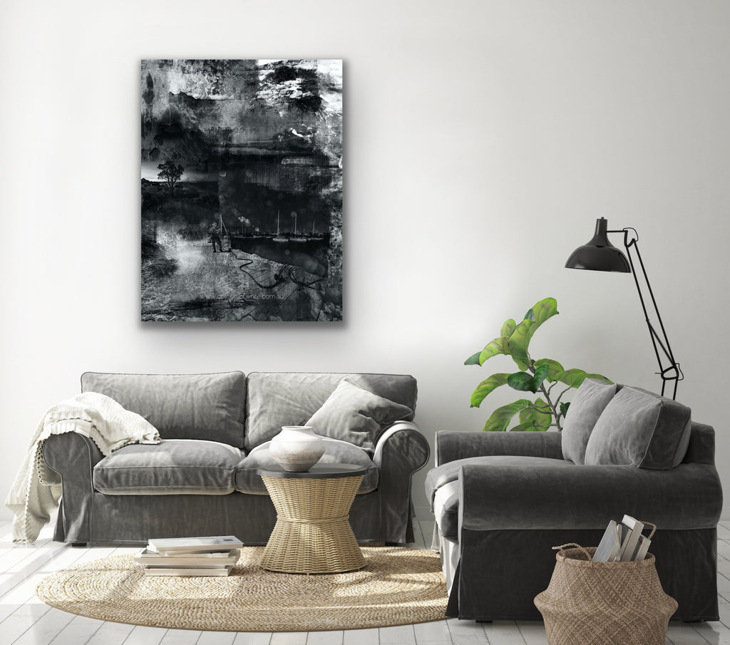 "Moonwalking" archival canvas print by Durham J White, featuring a monochrome layered photographic artwork of Mornington Pier with a lone figure and boats, in deep carbon blacks, graphite mid-tones, and crisp whites. Styled in a lounge setting.