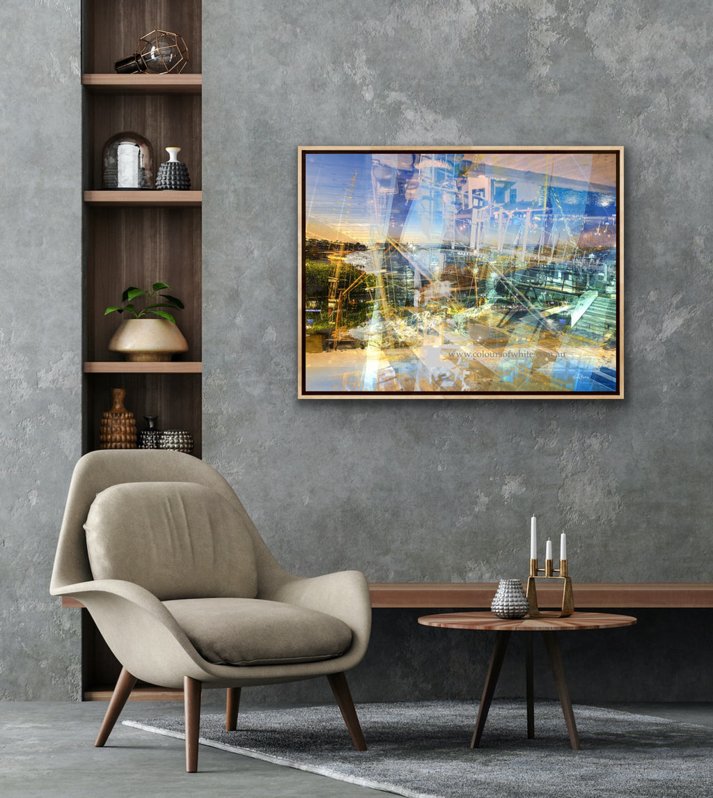“Keeping Up a Pier Glance 2” archival canvas print by Durham J White, featuring a layered photographic artwork of the Mornington waterfront in luminous pastel blues, subtle lemon highlights, and warm orange accents. Featured framed in a refined grey toned interior.