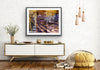 “Keeping Up a Pier Glance 3” glass-framed fine art print by Durham J White, featuring a layered photographic artwork of the Mornington waterfront in deep earthy purples, sandy caramel, and yellow-brown structural accents styled in a white open interior setting.