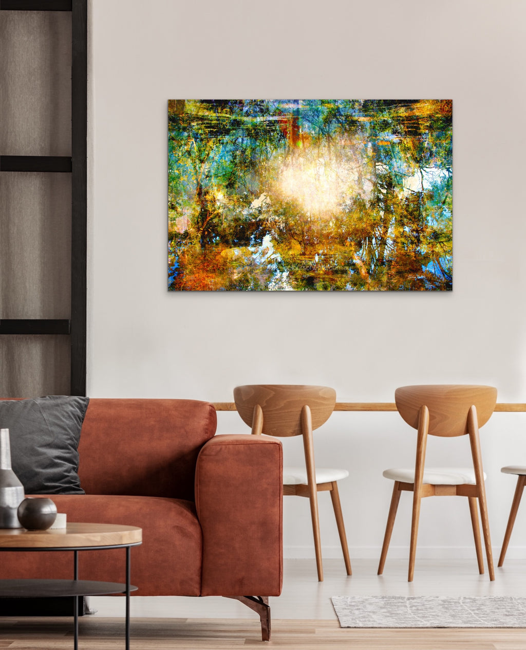 "Komorebi: Burnt Autumn Glow" archival canvas print by Durham J White, featuring a layered photographic artwork of sunlight blazing through an autumn forest canopy near Trentham, Victoria, in burnt amber, deep forest greens, and teal tones. Featured in a brown toned interior.