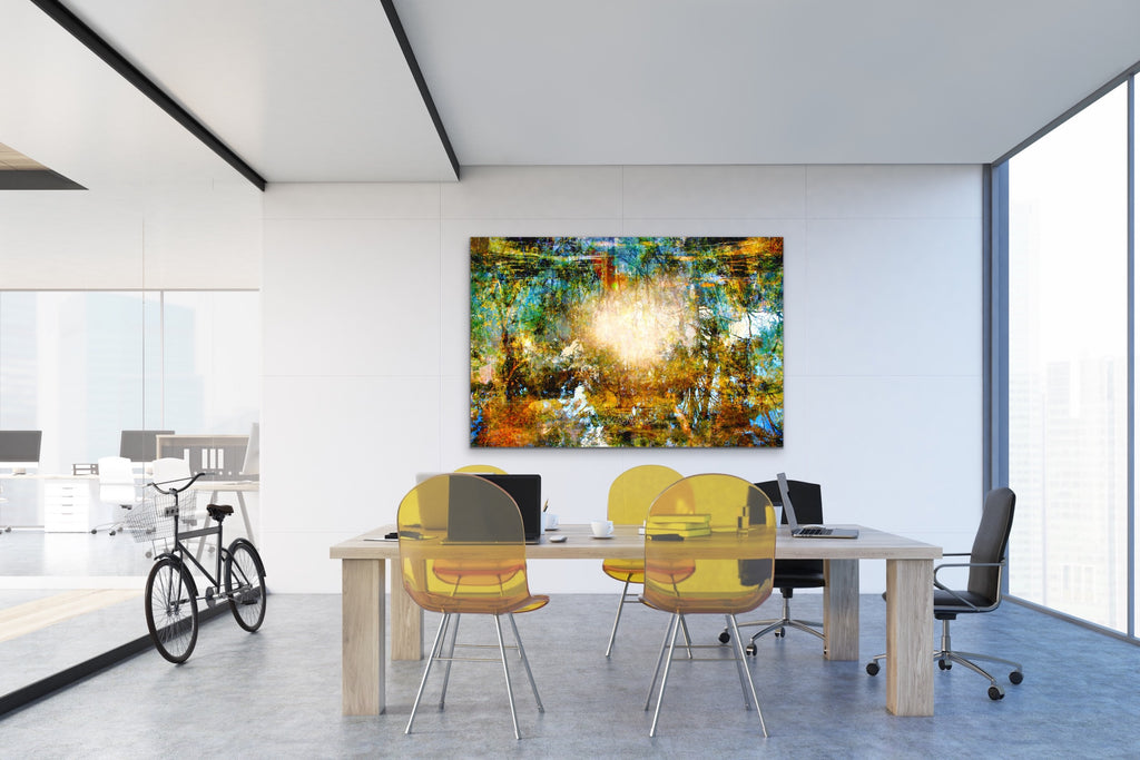 "Komorebi: Burnt Autumn Glow" archival canvas print by Durham J White, featuring a layered photographic artwork of sunlight blazing through an autumn forest canopy near Trentham, Victoria, in burnt amber, deep forest greens, and teal tones. Featured large in an open plan office space.
