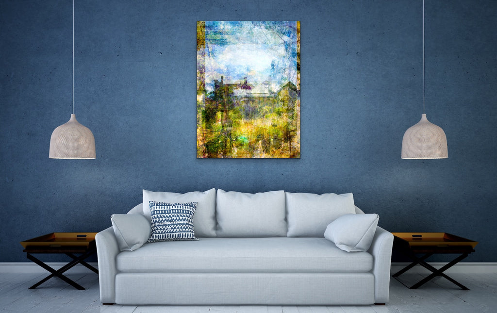 “Quaint” archival canvas print by Durham J White, featuring a layered photographic artwork of Trentham rooftops and chimneys in soft sky blues, crisp whites, and deep garden greens beneath a luminous sky. Featured in a living room.