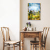 “Quaint” archival canvas print by Durham J White, featuring a layered photographic artwork of Trentham rooftops and chimneys in soft sky blues, crisp whites, and deep garden greens beneath a luminous sky. Small feature piece in a neutral toned cafe.