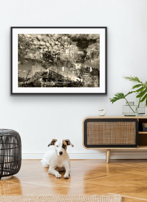 “Shades of the Historical Present Past” glass framed fine art print by Durham J White, featuring a monochromatic layered photographic artwork of Piper Street in Kyneton in rich greys, crisp whites, and ink blacks. Styled in a very neutral white beige toned living space.