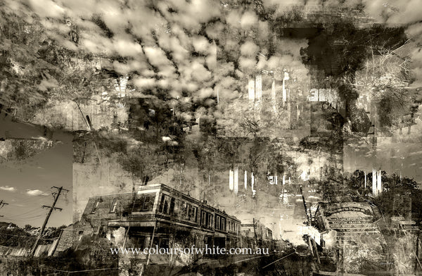 “Shades of the Historical Present Past” wall art by Durham J White, featuring a monochromatic layered photographic artwork of Piper Street in Kyneton in rich greys, crisp whites, and ink blacks in a semi-abstract way with dramatic clouds.