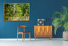 “The Water Coloured Grounds” archival canvas print by Durham J White, featuring a layered photographic artwork of the Australian countryside with lush meadow greens, warm earth tones, and a soft painterly finish.  Featured in a blue room.