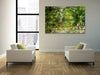 “The Water Coloured Grounds” archival canvas print by Durham J White, featuring a layered photographic artwork of the Australian countryside with lush meadow greens, warm earth tones, and a soft painterly finish.  Featured in high-rise city apartment.