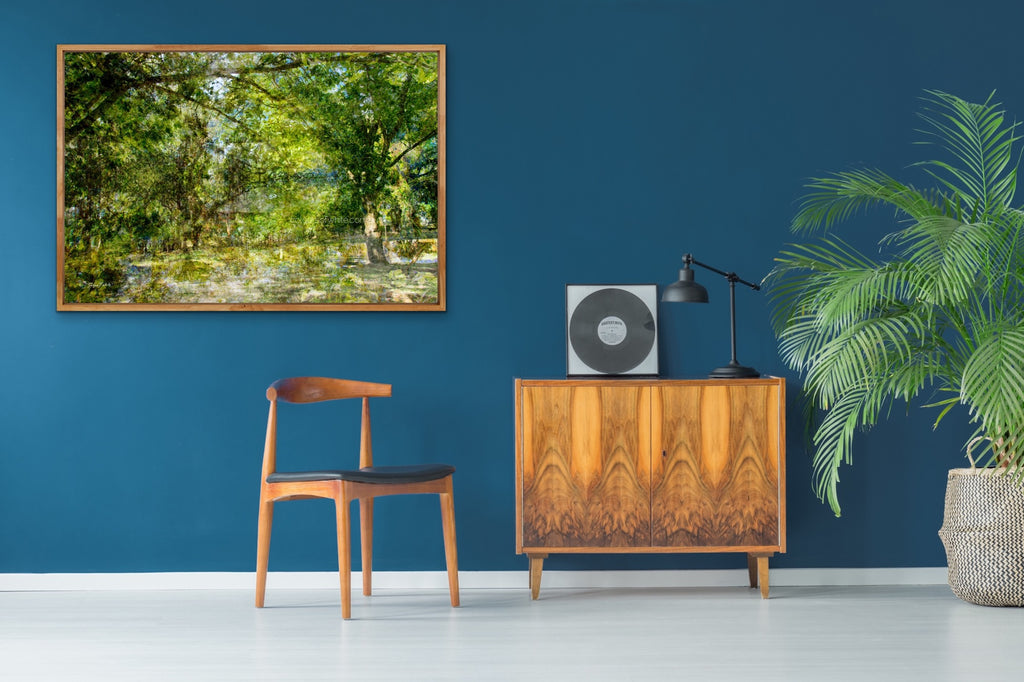 “The Water Coloured Grounds” archival canvas print by Durham J White, featuring a layered photographic artwork of the Australian countryside with lush meadow greens, warm earth tones, and a soft painterly finish.  Featured in a blue room.