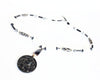 A black and white necklace with a jade dragon like carved pendant.