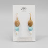 A pair of gold-plated hoop earrings with light blue howlite and small pearl accents