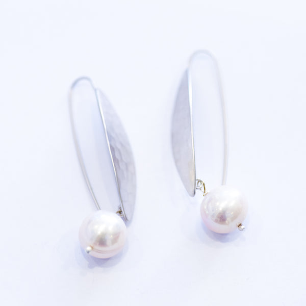 A pair of silver leaf earrings with a single freshwater pearl on each hook.