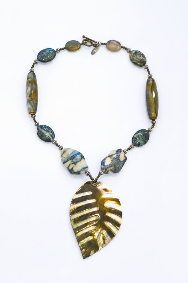 A khaki olive stone necklace with a leaf-shaped pendant and various colored gemstone accents on a white background.