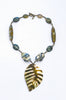 A khaki olive stone necklace with a leaf-shaped pendant and various colored gemstone accents on a white background.
