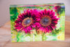 A rectangular tile featuring a vibrant image of sunflowers with rich lime colors on a white background.