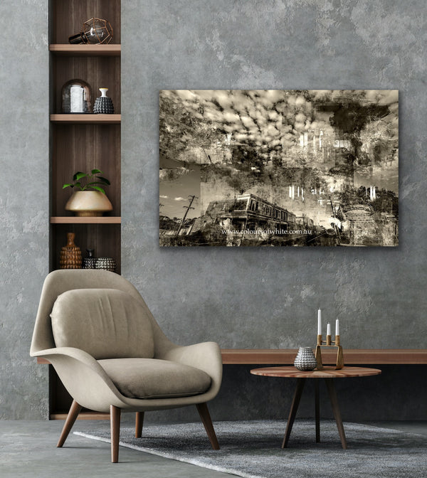 An industrial feeling layered photographic artwork that features the historical Piper Street, Kyneton in a semi-abstract way. Epic clouds.  Featured unframed in a rendered grey modern room