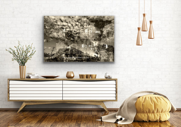 An industrial feeling layered photographic artwork that features the historical Piper Street, Kyneton in a semi-abstract way. Epic clouds. Featured unframed in an open natural white walled and timber floored living space.