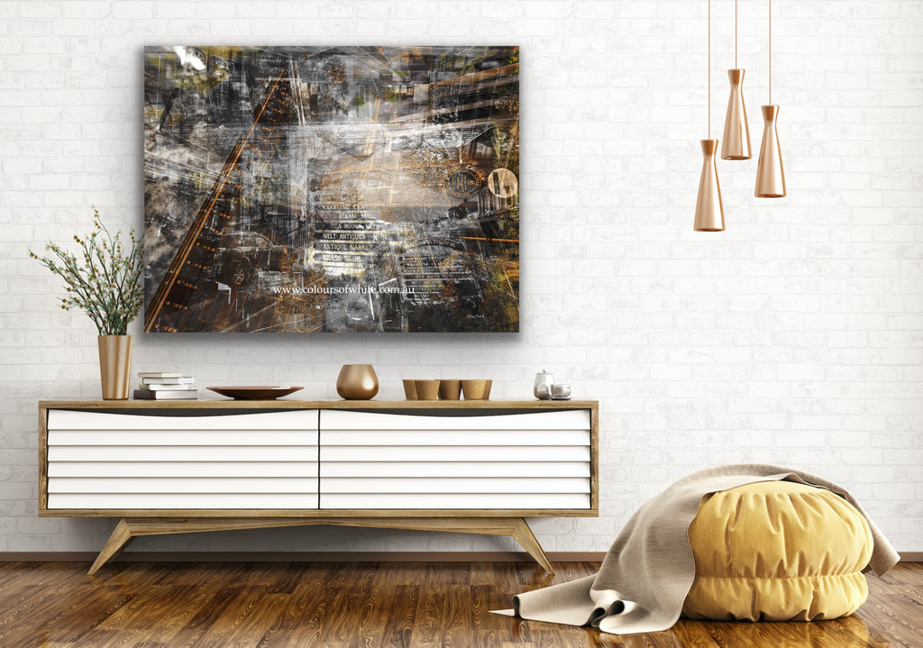 A black and white layered photographic artwork featuring a blurred industrial scene with historical buildings, predominantly in shades of grey, copper tones, and varying perspectives. 
