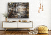 A black and white layered photographic artwork featuring a blurred industrial scene with historical buildings, predominantly in shades of grey, copper tones, and varying perspectives. 